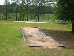a horseshoe pit and volleyball court